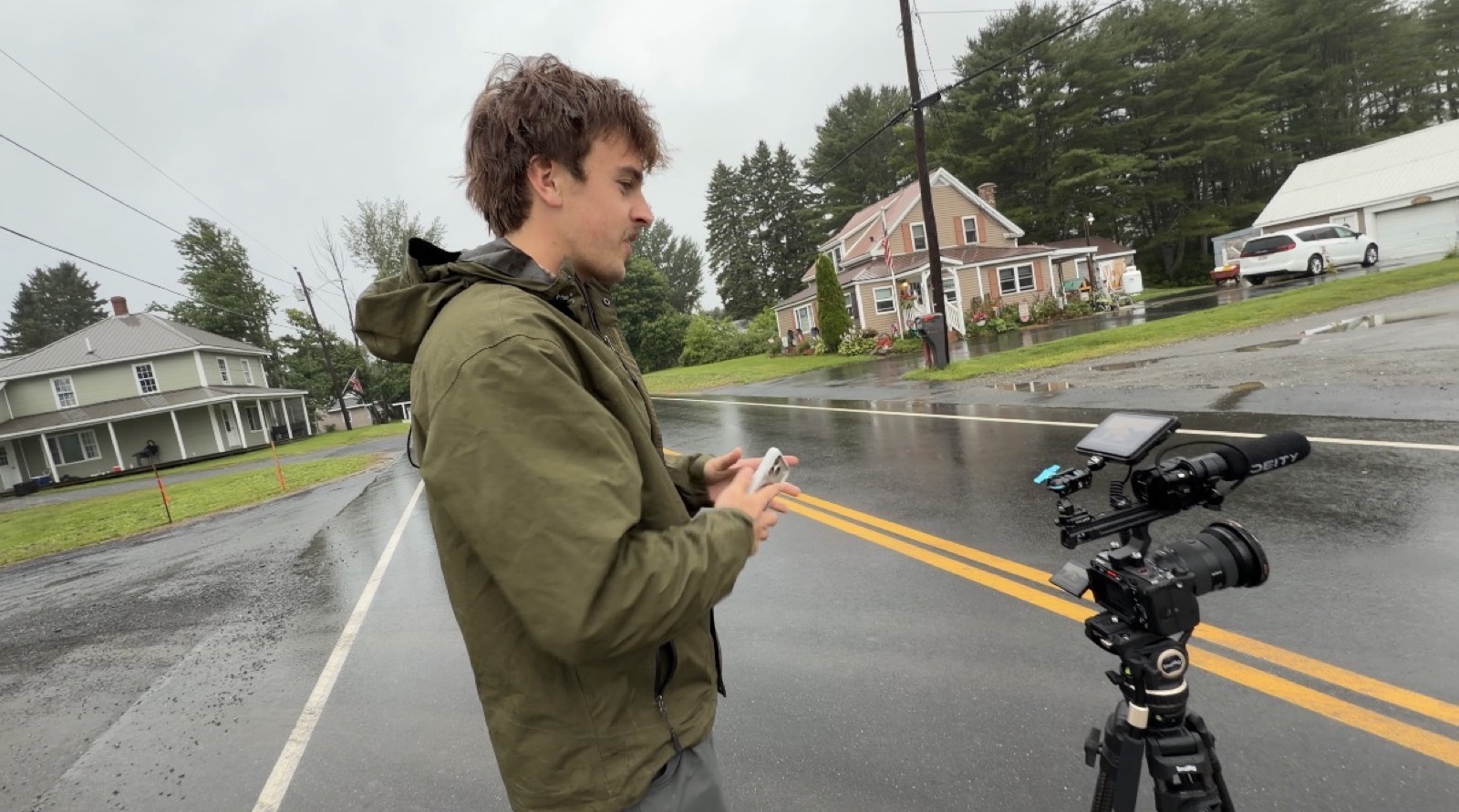 Jake on a wet road beside a tripod